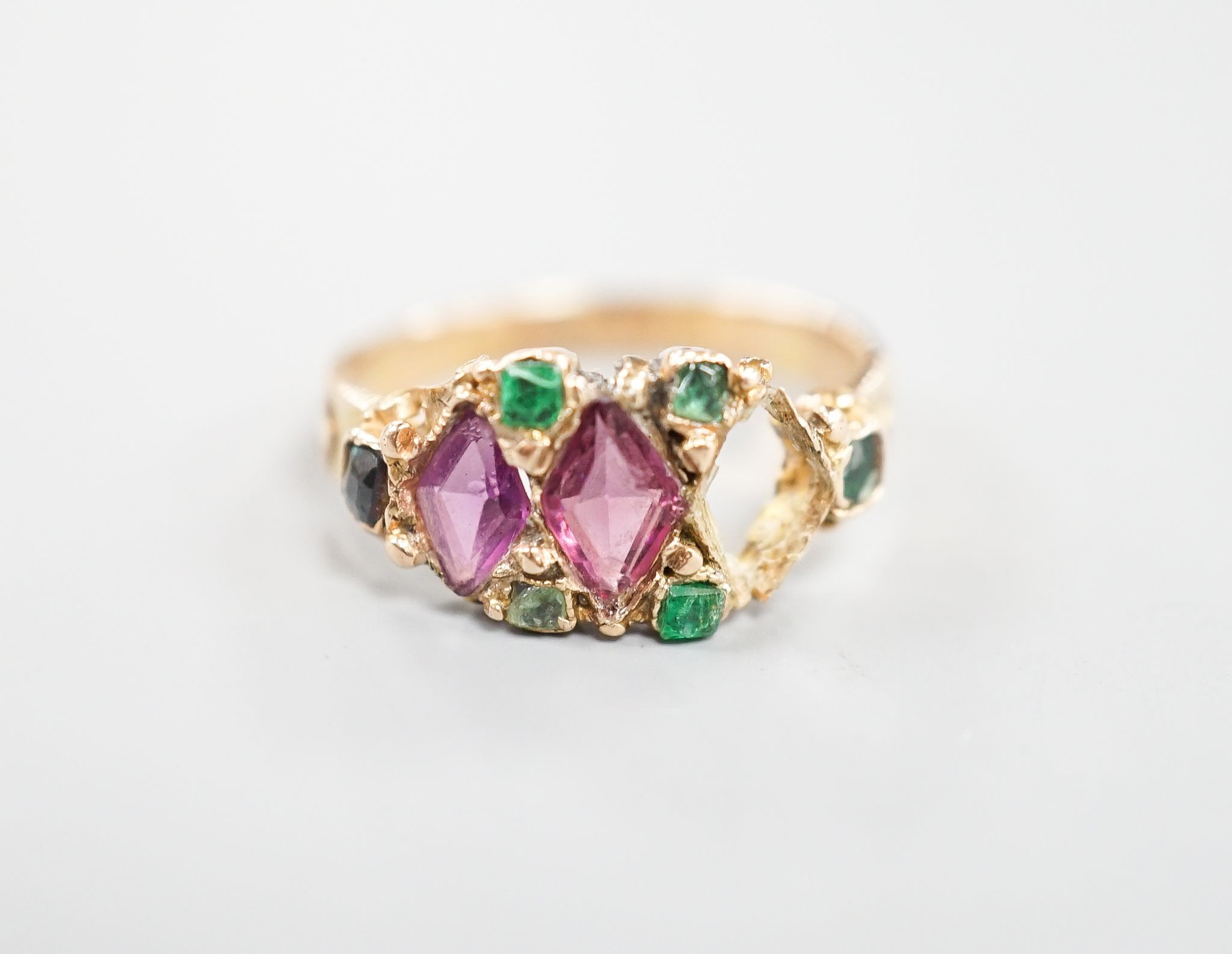 A late Victorian 15ct gold, garnet and emerald set dress ring(stone missing & stone replacement?), size L, gross 2.2grams.